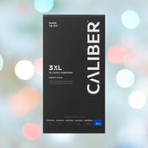 Black box of Caliber 3XL - Extra Large Condoms (69mm Wide) featuring "Made to Fit" text, set against a softly blurred background with colorful, festive lights.